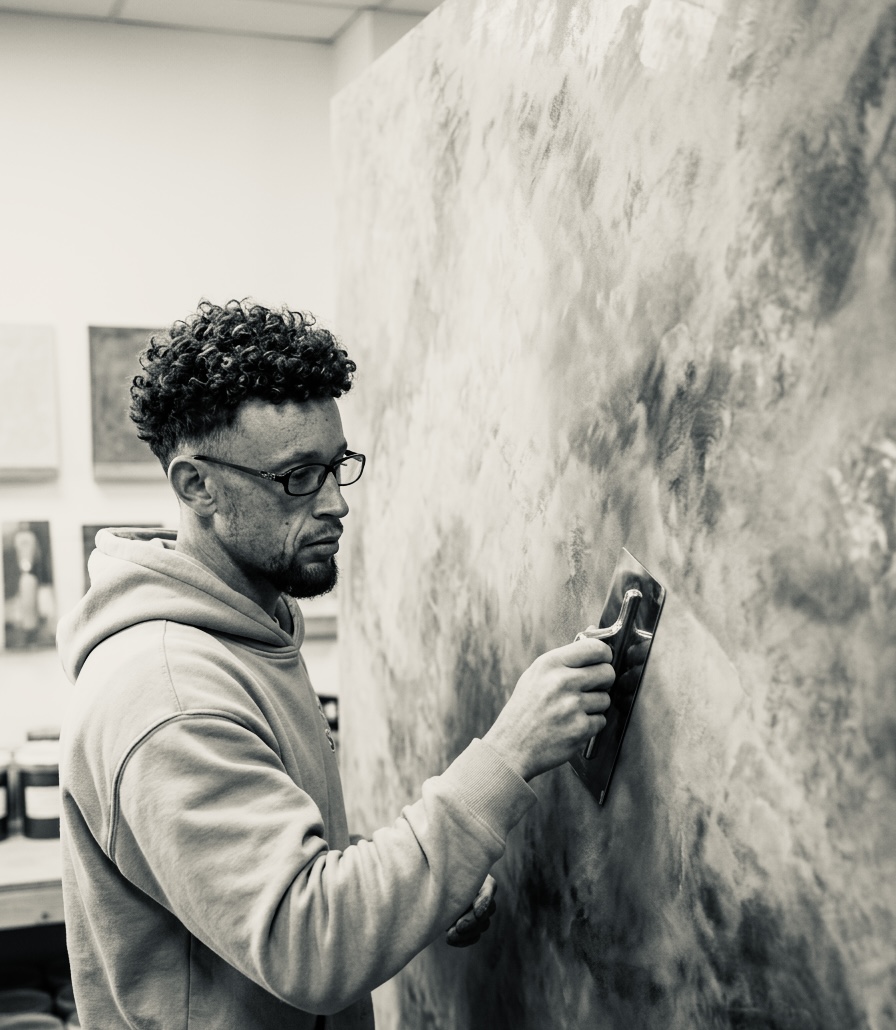 Calvin applying a wall finish on site